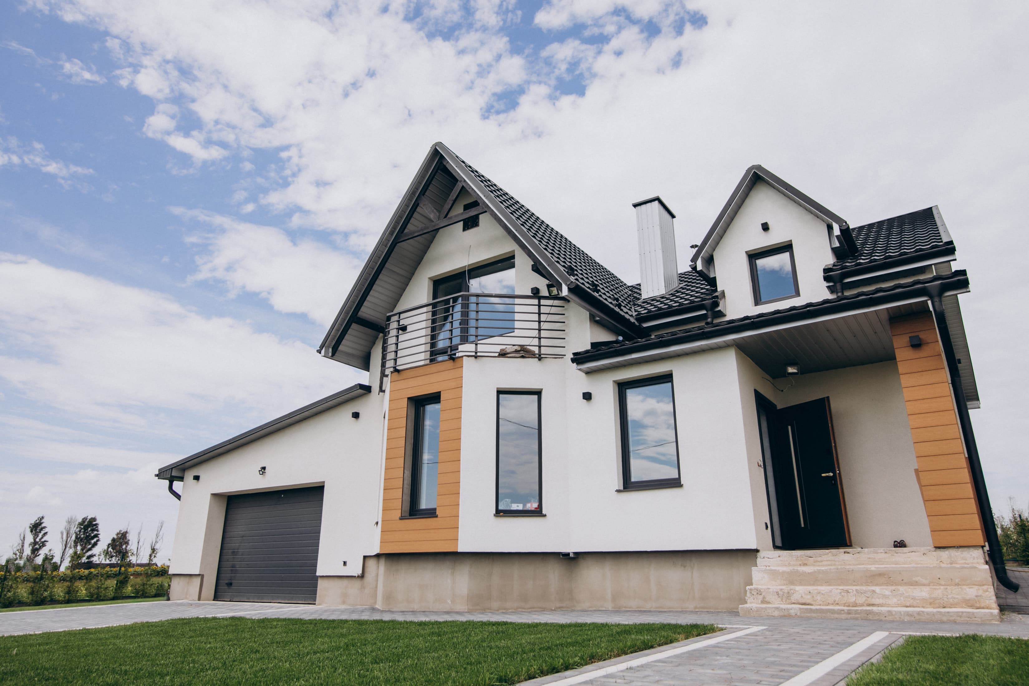Modern single-family home with a two-car garage set on an open field